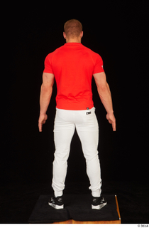 Dave black sneakers dressed red t shirt standing white pants…